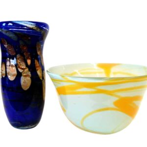 A blue vase and a white bowl with orange patterns, both made of glass.