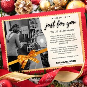 Gift card for a glassblowing experience with festive decorations and a gold ribbon.
