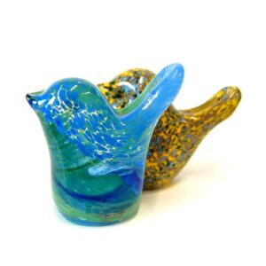 Two colorful glass bird sculptures on a white background.