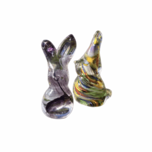 Two small glass animal figurines, one rabbit and one howling wolf, on a white background.